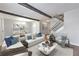 Bright living room with staircase, modern furnishings, decorative beams, and an adjacent dining area at 748 Garden View Dr, Stone Mountain, GA 30083