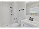 Modern bathroom featuring a tiled shower, black fixtures, and a vanity sink at 219 Holcomb Ferry Rd, Roswell, GA 30076