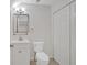 Bathroom with tile floors, sink with cabinet, square mirror and modern lighting, and a toilet at 219 Holcomb Ferry Rd, Roswell, GA 30076