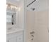 Bright bathroom featuring a shower over tub, vanity sink, and a window for natural light at 219 Holcomb Ferry Rd, Roswell, GA 30076