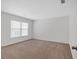 Bedroom featuring neutral colored carpet and large window offering natural light at 219 Holcomb Ferry Rd, Roswell, GA 30076