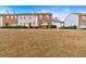 View of townhomes with well-manicured lawns in a residential community at 219 Holcomb Ferry Rd, Roswell, GA 30076