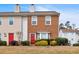 Charming townhome featuring a red front door and well-maintained landscaping at 219 Holcomb Ferry Rd, Roswell, GA 30076