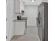 Galley kitchen featuring stainless steel appliances, granite counters, tile flooring, and white cabinets at 219 Holcomb Ferry Rd, Roswell, GA 30076