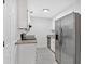 Galley kitchen featuring stainless steel appliances, granite counters, tile flooring, and white cabinets at 219 Holcomb Ferry Rd, Roswell, GA 30076