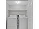 Laundry room with side by side white washer and dryer and shelf above at 219 Holcomb Ferry Rd, Roswell, GA 30076