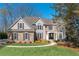 Charming home featuring stone accents, gray siding, manicured lawn, and beautiful landscaping at 5303 Whitehaven Park Se Ln, Smyrna, GA 30126