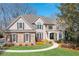 Charming home featuring stone accents, gray siding, manicured lawn, and beautiful landscaping at 5303 Whitehaven Park Se Ln, Smyrna, GA 30126