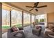 Covered patio with comfortable seating, ceiling fan, and view of landscaped backyard with hot tub at 5303 Whitehaven Park Se Ln, Smyrna, GA 30126