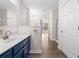 Bright bathroom vanity area featuring a large mirror and modern fixtures, with closet access at 1955 Nocturne Dr # 3301, Alpharetta, GA 30009