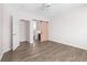 Bedroom with gray floors features a sliding barn door and a standard door to other rooms at 1955 Nocturne Dr # 3301, Alpharetta, GA 30009