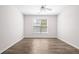 Clean, empty bedroom showcasing hardwood floors, a ceiling fan, and natural light at 1955 Nocturne Dr # 3301, Alpharetta, GA 30009