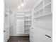 Organized walk-in closet with custom shelving, drawers, and modern light fixtures at 1955 Nocturne Dr # 3301, Alpharetta, GA 30009