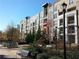 A multi-story condo building with balconies and landscaped garden area at 390 17Th St # 2059, Atlanta, GA 30363