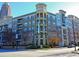 Beautiful four-story condo building featuring a tower and individual balconies on a sunny day at 390 17Th St # 2059, Atlanta, GA 30363