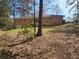 Expansive backyard shows a brick home and lush greenery, perfect for outdoor living and creating lasting memories at 3685 Emily Way, Atlanta, GA 30349