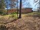 View of backyard featuring brickwork and lawn on a sunny day at 3685 Emily Way, Atlanta, GA 30349