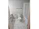 Bright renovated bathroom features sleek, clean finishes and marble floors, with white fixtures and natural light enhancing the space at 3685 Emily Way, Atlanta, GA 30349