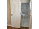 Bathroom featuring a glass shower, marble tile floor, and new toilet, visible behind an open door at 3685 Emily Way, Atlanta, GA 30349