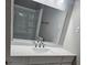 Bright bathroom featuring a sleek, modern vanity with a white countertop and a large mirror, reflecting the bath and shower at 3685 Emily Way, Atlanta, GA 30349