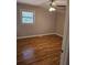 Bedroom featuring hardwood floors, neutral walls, and a window at 3685 Emily Way, Atlanta, GA 30349