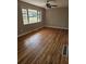 Sunlit bedroom featuring gleaming hardwood floors and a large window at 3685 Emily Way, Atlanta, GA 30349