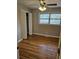 Cozy bedroom with hardwood floors, ceiling fan, closet and a window bringing in natural light at 3685 Emily Way, Atlanta, GA 30349