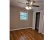 Comfortable bedroom with hardwood floors, ceiling fan, and a closet at 3685 Emily Way, Atlanta, GA 30349