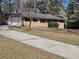 Lovely brick home featuring a convenient garage and beautiful landscape at 3685 Emily Way, Atlanta, GA 30349