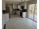 Renovated kitchen with marble tile flooring, white cabinets, and stainless steel appliances at 3685 Emily Way, Atlanta, GA 30349