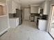 Updated kitchen featuring white cabinets, stainless steel appliances, and marble tile flooring at 3685 Emily Way, Atlanta, GA 30349
