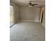 Inviting living room featuring marble tile flooring, ceiling fan, and sliding glass door at 3685 Emily Way, Atlanta, GA 30349