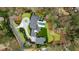Aerial shot of an upscale property showcasing a long driveway and serene wooded surroundings at 5245 Kenbrook Way, Sandy Springs, GA 30327