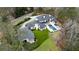 Stunning aerial view of a modern luxury home with a pool, spacious lawn, and expertly landscaped grounds at 5245 Kenbrook Way, Sandy Springs, GA 30327