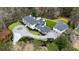 Expansive estate with circular driveway, meticulously manicured lawn, and a connected multi-car garage at 5245 Kenbrook Way, Sandy Springs, GA 30327