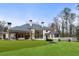 Backyard of home with artificial turf and large windows providing plenty of natural light to the interior at 5245 Kenbrook Way, Sandy Springs, GA 30327