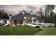 Secluded backyard with a sleek pool, covered patio, and lush green lawn perfect for relaxation at 5245 Kenbrook Way, Sandy Springs, GA 30327