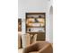 Wet bar with a marble countertop, beautiful display shelves, and hardwood cabinets at 5245 Kenbrook Way, Sandy Springs, GA 30327