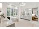 A bright and modern bathroom with a soaking tub and vanity with natural lighting and stylish fixtures at 5245 Kenbrook Way, Sandy Springs, GA 30327