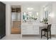 Vanity area with double mirrors, lots of drawers for storage, and a view of the walk-in closet at 5245 Kenbrook Way, Sandy Springs, GA 30327
