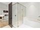 Bathroom featuring a glass shower and a soaking tub, conveniently connected to the bedroom at 5245 Kenbrook Way, Sandy Springs, GA 30327