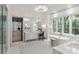 A luxurious bathroom with a soaking tub, dual vanity sinks, and a glass enclosed shower at 5245 Kenbrook Way, Sandy Springs, GA 30327