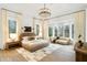 A luxurious main bedroom features a sitting area, natural light, and stylish decor with a contemporary aesthetic at 5245 Kenbrook Way, Sandy Springs, GA 30327