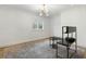 Spacious bedroom with a light grey rug, minimal furniture, modern lighting, and a large window at 5245 Kenbrook Way, Sandy Springs, GA 30327
