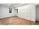 Bedroom with modern built-in cabinets and hardwood floors, offering ample storage and a clean aesthetic at 5245 Kenbrook Way, Sandy Springs, GA 30327