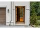 Grand entrance featuring a dark steel door and lush landscaping at 5245 Kenbrook Way, Sandy Springs, GA 30327