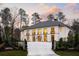 Beautiful home with large windows, an inviting entrance, and professional landscaping at 5245 Kenbrook Way, Sandy Springs, GA 30327