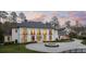 Luxury home with a circular driveway, decorative fountain, and lush landscaping at 5245 Kenbrook Way, Sandy Springs, GA 30327