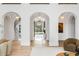 Grand foyer featuring arched entries, herringbone floors, and a view of the fountain at 5245 Kenbrook Way, Sandy Springs, GA 30327