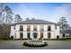 Charming two-story home with a circular driveway and fountain, beautifully landscaped at 5245 Kenbrook Way, Sandy Springs, GA 30327